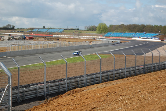 A Sainteloc Audi heads down Farm Straight with the construction sight of the new 'Wing' pits in the background.