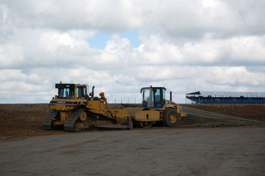 Earth moving equipment sits idle while the race weekend continues around it.